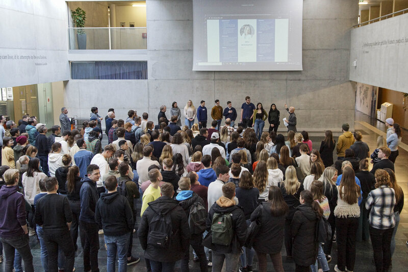 Eine große Gruppe von Menschen versammelt sich in der modernen Aula der FH Kufstein Tirol. | © FH Kufstein Tirol
