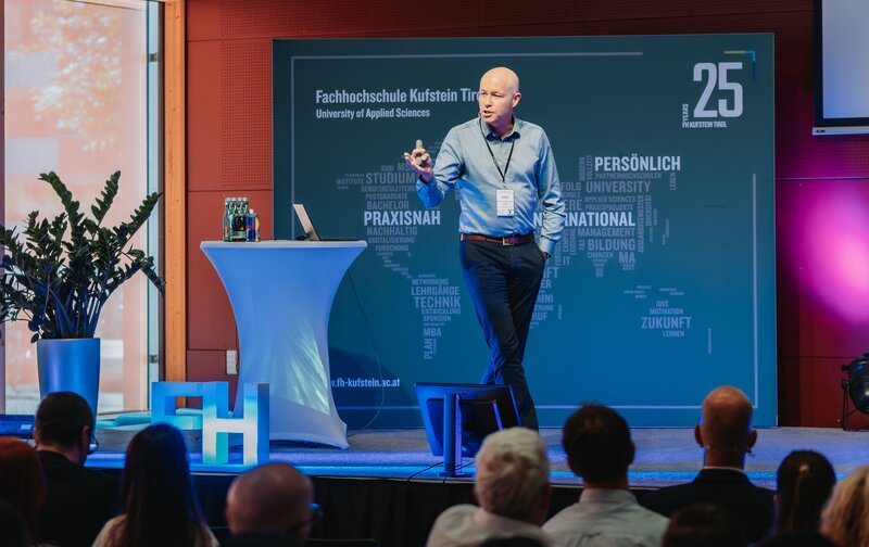 Prof. (FH) Dr. Roman Stöger auf dem Podium im Festsaal der FH Kufstein Tirol beim 1. KI-Kongress.  | © FH Kufstein Tirol