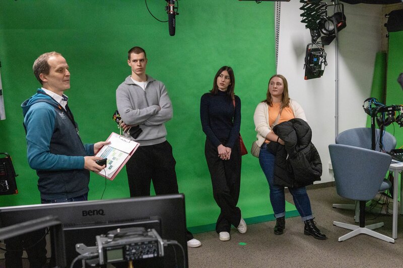 Personen stehen vor einem Green Screen