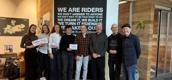 Studierende mit Louis Moustakas und die Auftraggeber von CHILL stehen für ein Gruppenfoto zusammen. 