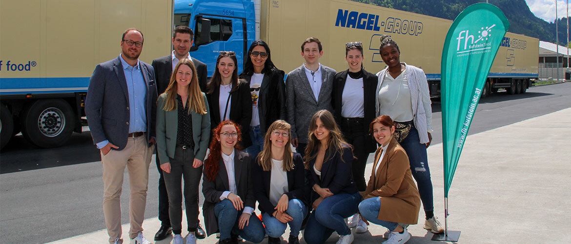praxisprojekt_eröffnungsfeier_nagel Studentinnen mit den Verantwortlichen auf dem Gelände der Nagel Group vor einem LKW.